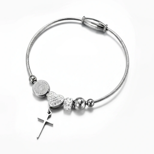Silver bracelet with heart and cross charms on a white background, featuring 'Guided by Cross' branding.