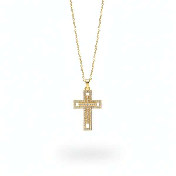 Gold cross necklace with clear stones on a white background