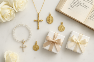 Catholic jewelry gift guide flat lay with crucifix necklaces, Virgin Mary medals, and gift boxes