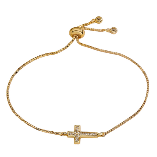 Gold bracelet with a cross charm on a white background, featuring the brand 'Guided by Cross'.