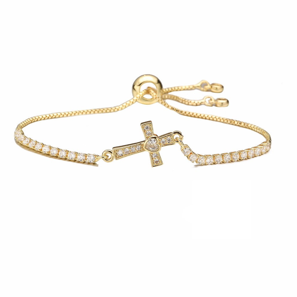 Gold bracelet with a cross charm on a white background