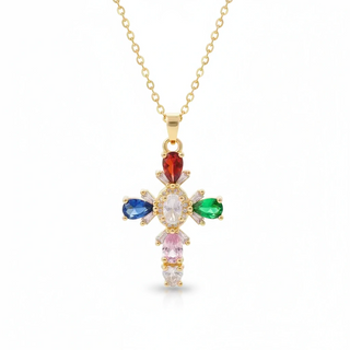 Gold cross pendant with colorful gemstones on a white background, branded 'Guided by Cross'.