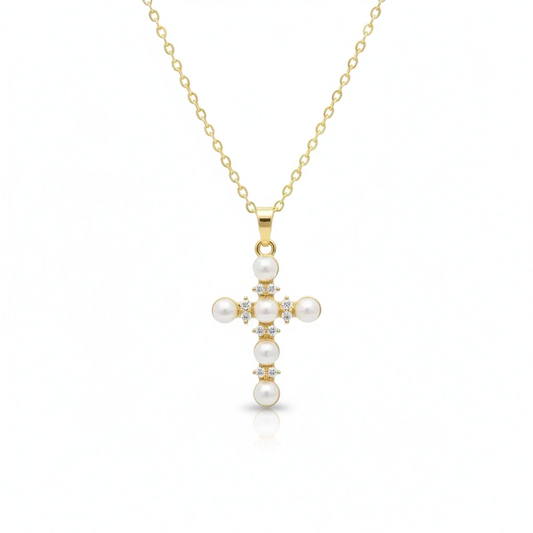 Gold necklace with a cross pendant featuring pearls on a white background, branded 'Guided by Cross'.