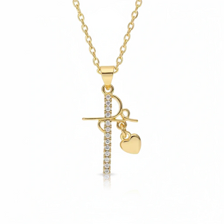 Gold necklace with a cross and heart pendant on a white background