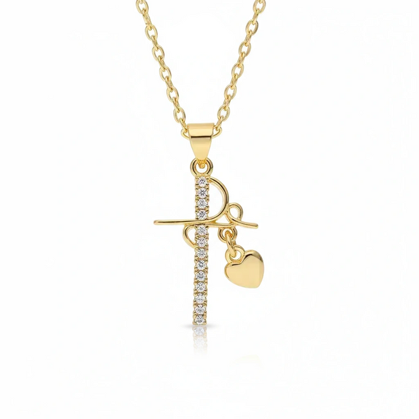 Gold necklace with a cross and heart pendant on a white background